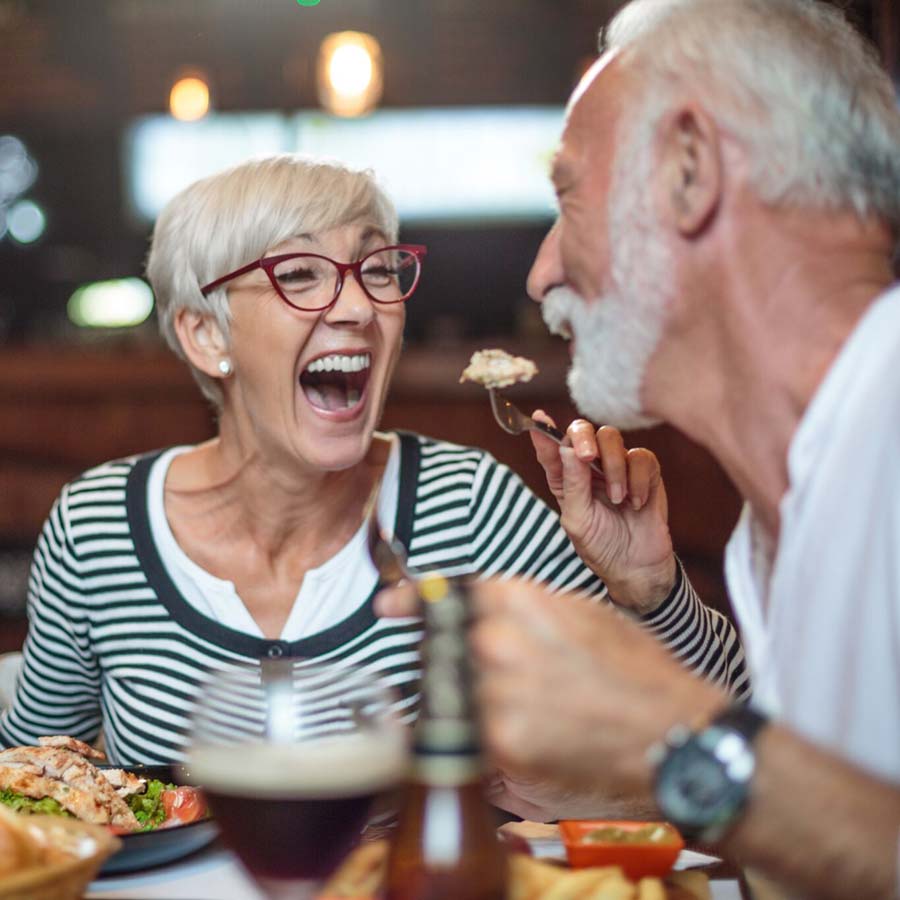 an image of a wife feeding her husband in a funny way