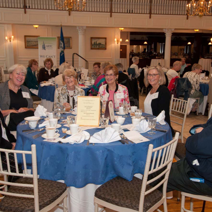 group of women sitting around a table